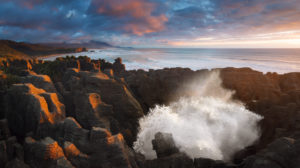 Fountain from a blowhole at Pancake Rocks in the sunset, Punakaiki, Paparoa National Park, New Zealand Fountain from a blowhole at Pancake Rocks in the sunset, Punakaiki, Paparoa National Park, New Zealand